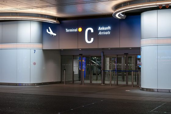 Illuminated arrivals entrance of Terminal 1 C at Frankfurt Airport at night